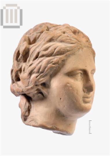 Head of a female clay-figurine