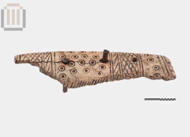 Part of a bone handle hilt-sheath from a knife from Doliani