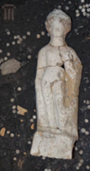 Male figurine holding a cockerel