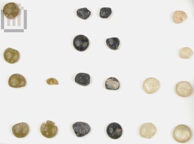 Parts of two glass counters for the playing of board games