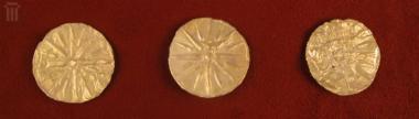 Three small gold discs with matrix-hammered relief sixteen-pointed star from the decoration of a textile