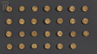 Twenty seven gold discs with rosettes