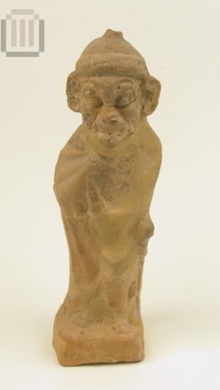 Terracotta figurine of a mantled male figure with an ungly head