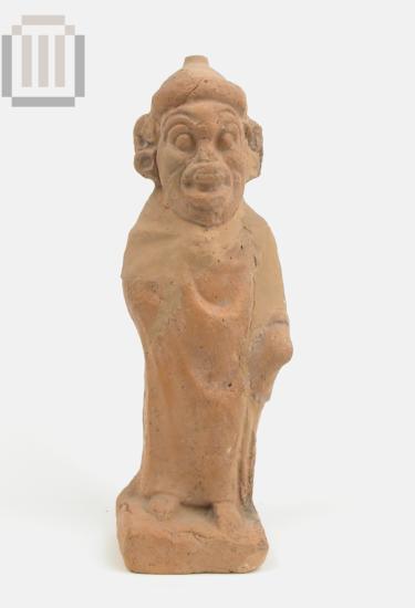 Terracotta figurine of a mantled male figure with an ungly head