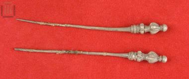 Two silver pins