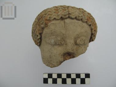 Part of clay kouros head