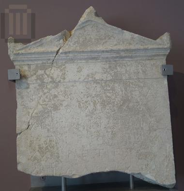 Inscribed funerary stele with a pedimental crowning