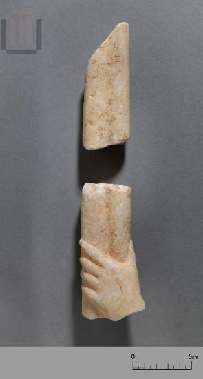 Hand of a small marble statue with a torch