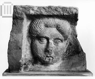 Inscribed marble funerary relief with a bearded man