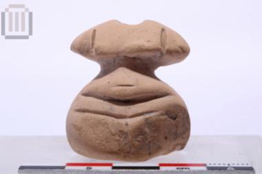 Clay stylized female figurine