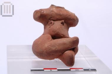 Clay seated female figurine