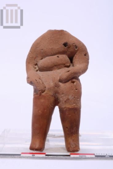 Clay seated male figurine