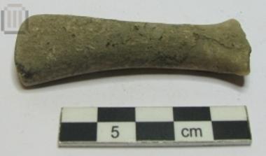 Triangular head of a stone figurine