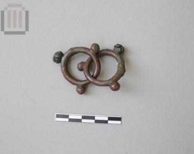 A pair of bronze pendants in the form of hoops with three projections