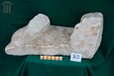 Fragment of a statue standing on a plinth