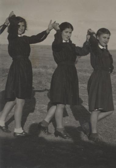 Girls wearing uniforms made of English Blackout material, the only cloth available after the war