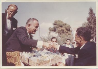 AFS graduate Mike Spiropoulos shaking the hand of U.S. V.P. Johnson, Bruce Lansdale is behind them, 1963