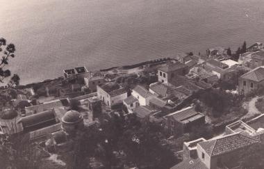 Άποψη της Κάτω Πόλης της Μονεμβασιάς. Λήψη από την Άνω Πόλη. Διακρτίνεται ο ναός του Ελκόμενου Χριστού στην κεντρική πλατεία του οικισμού.